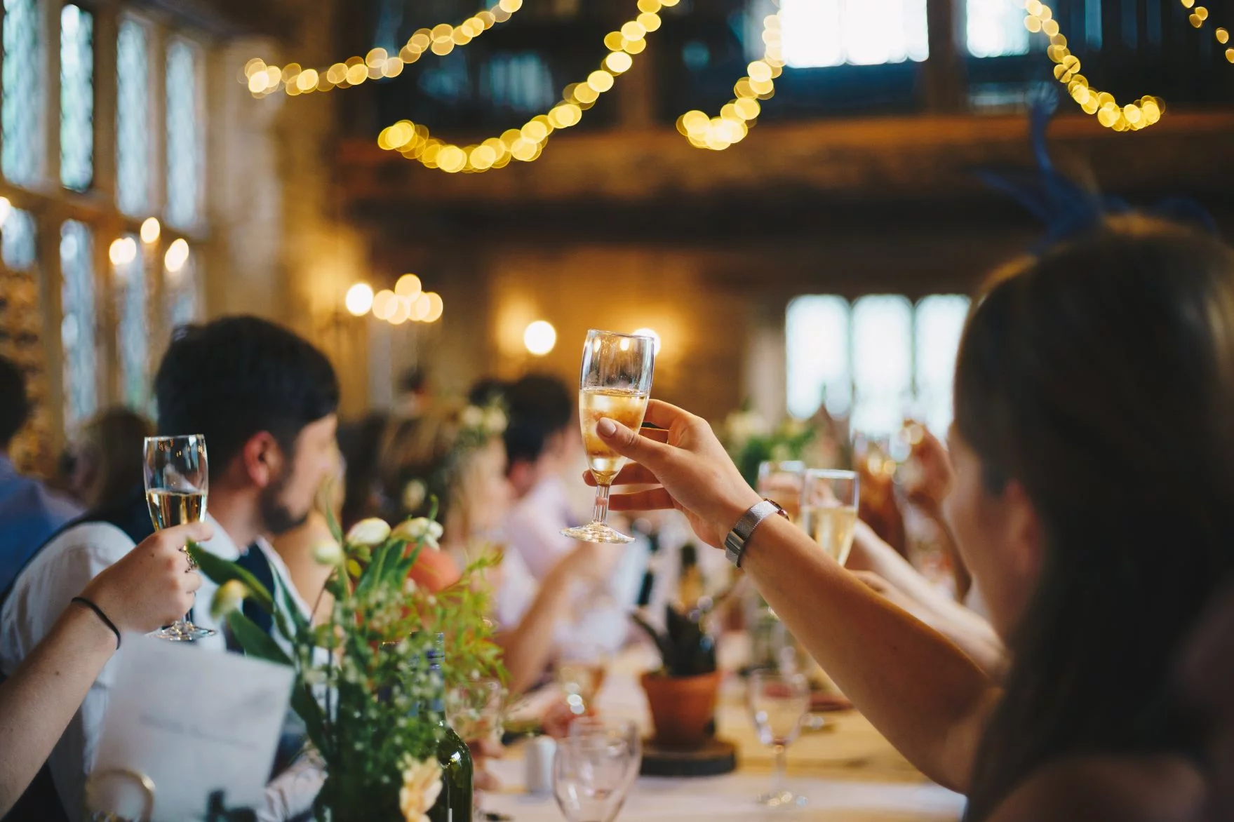 A group of people toasting champagne at a wedding reception.