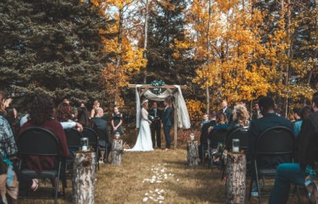 A fall wedding ceremony in a wooded area.