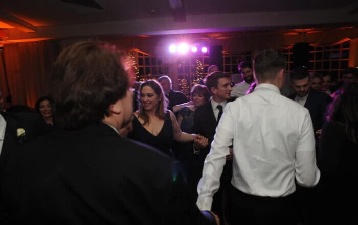 A lively gathering of individuals joyfully dancing at a party.