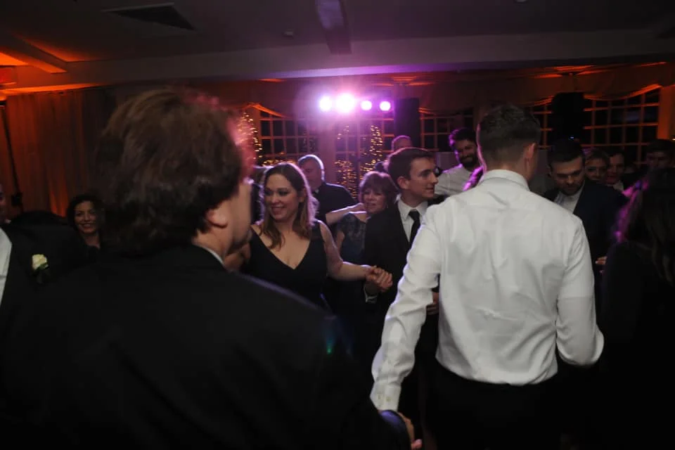 A lively gathering of individuals joyfully dancing at a party.