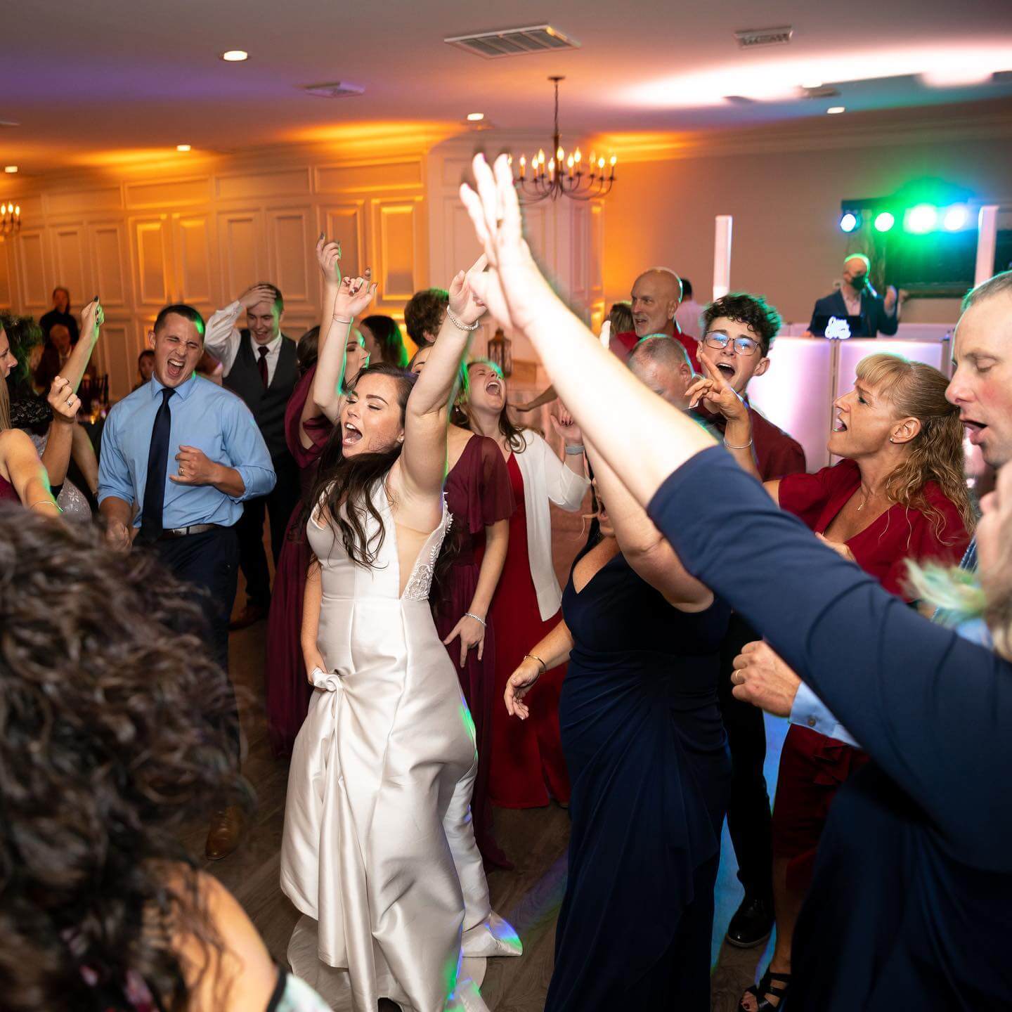 Wedding DJs in Connecticut spinning tunes for a bride and groom dancing at their reception.