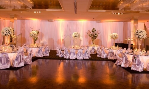 A wedding reception set up with white linens and white flowers, perfect for Connecticut weddings.